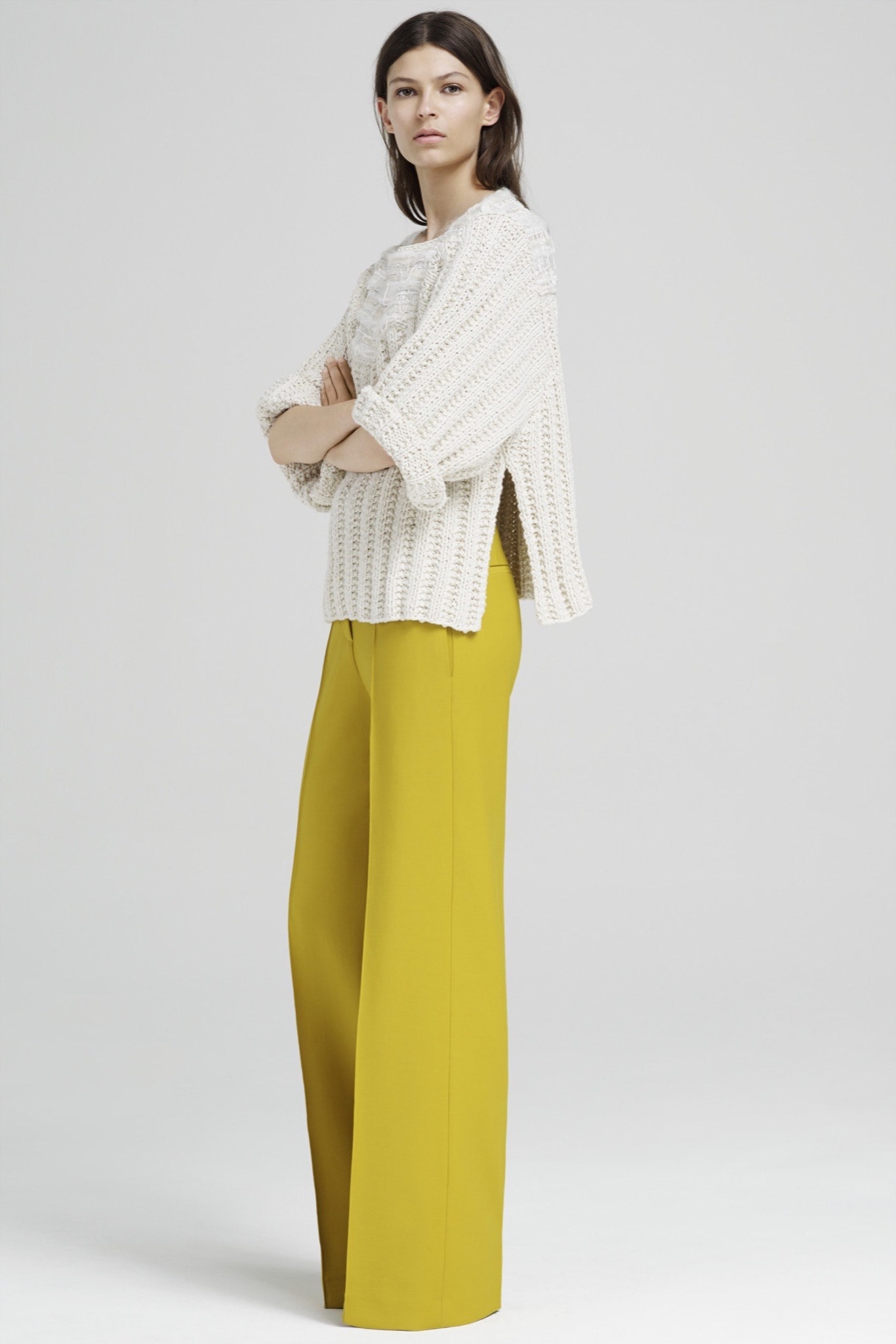white relaxed sweater and yellow tailored pants