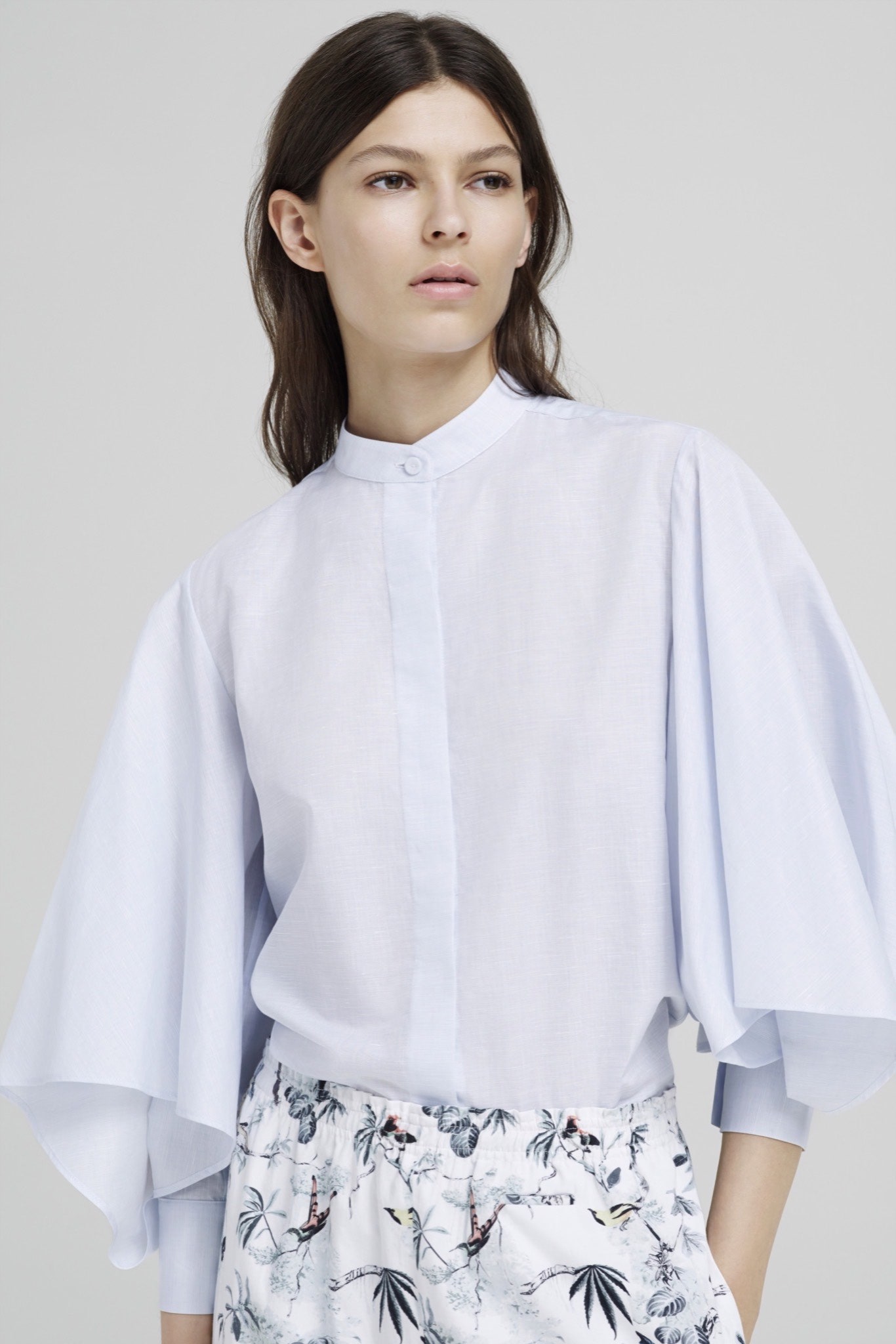 light blue relaxed blouse and white flared skirt