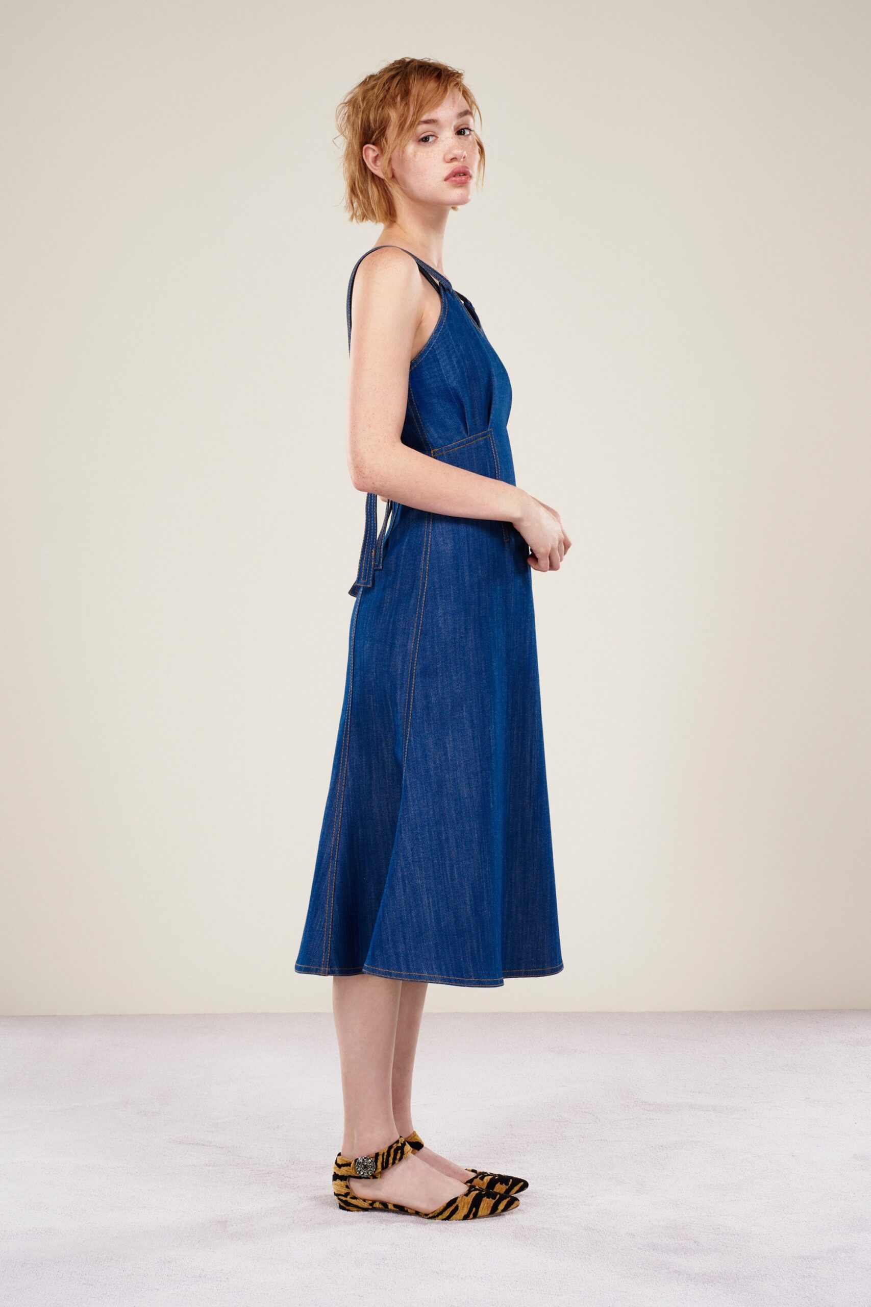 blue denim midi dress with animal-print shoes