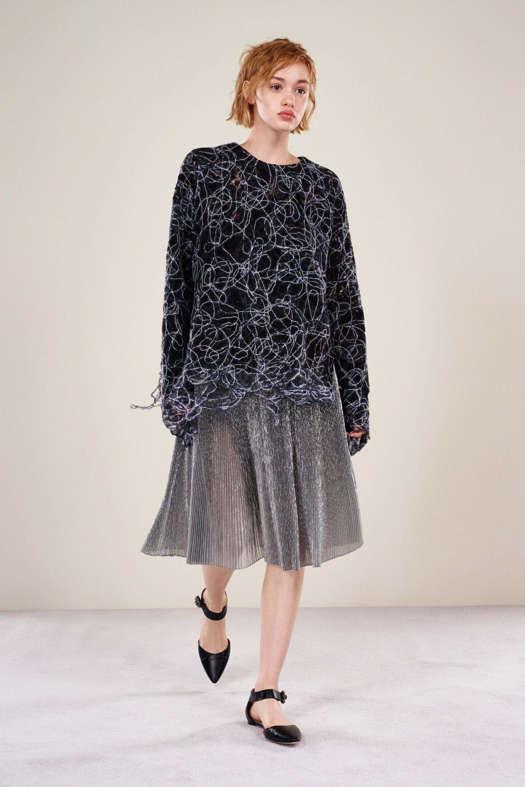 black oversized velvet top and silver pleated skirt