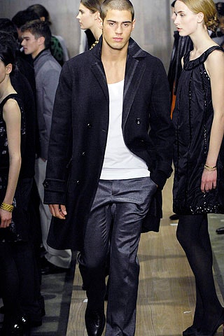 black wool coat gray pants white tank-top