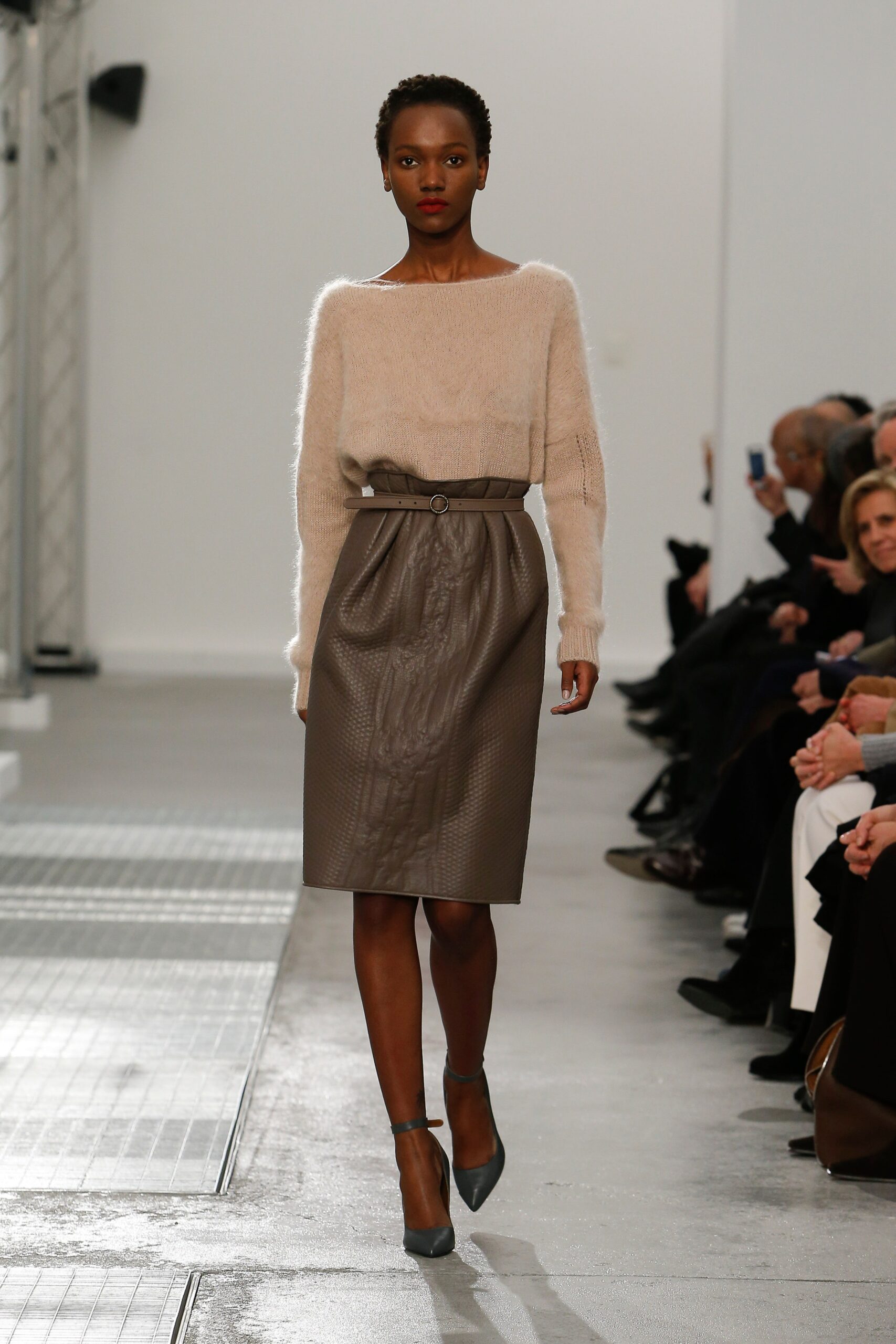 beige wool sweater and brown leather skirt