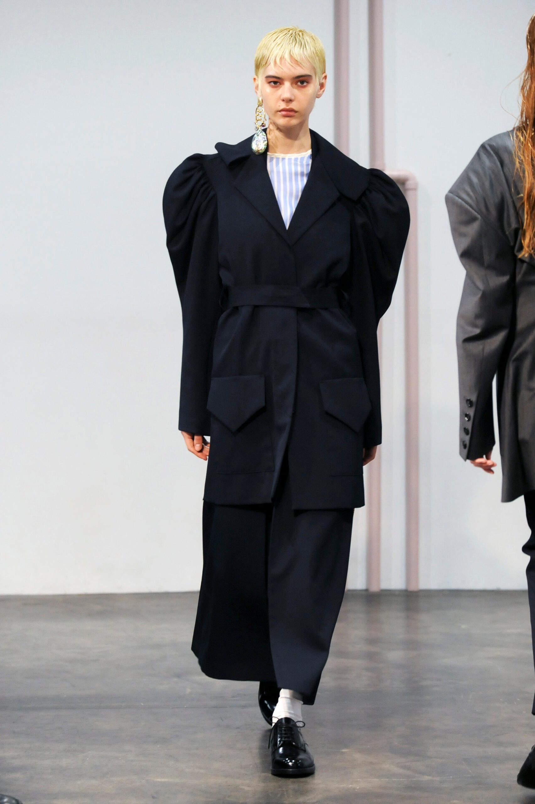 black wool relaxed coat and white shirt
