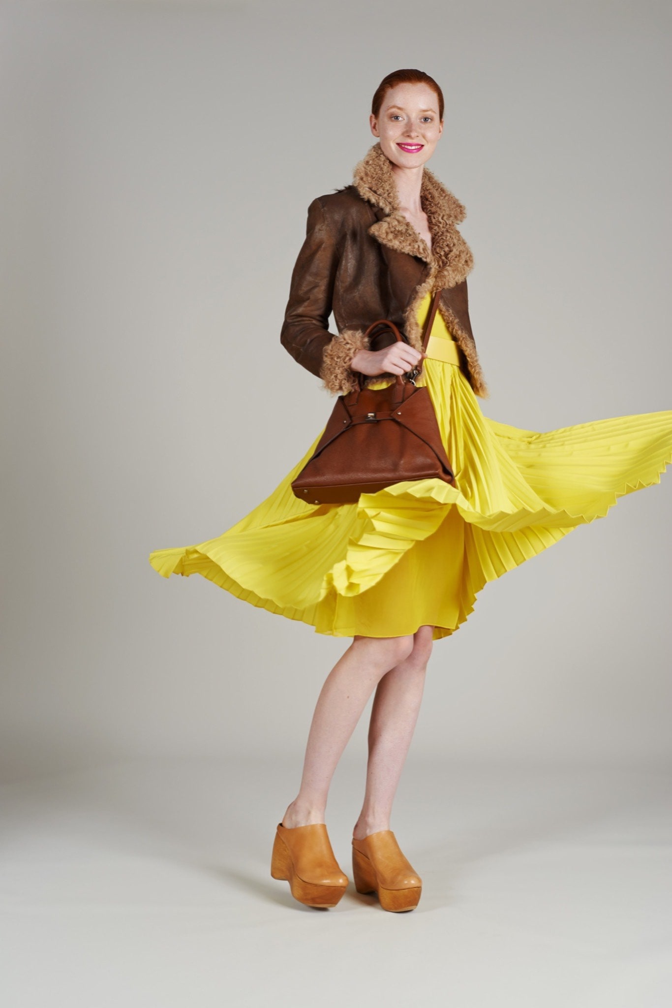 yellow pleated midi dress with brown jacket