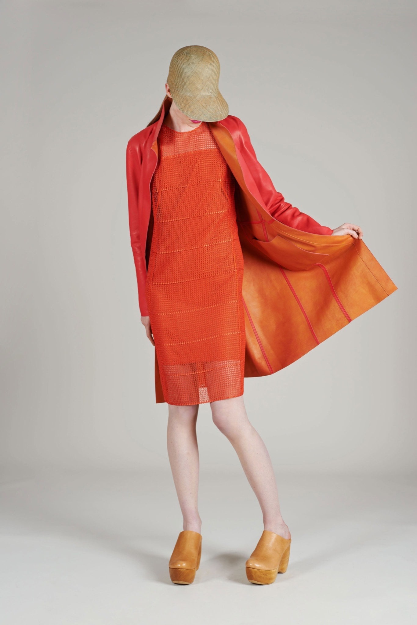 orange fitted dress with red coat
