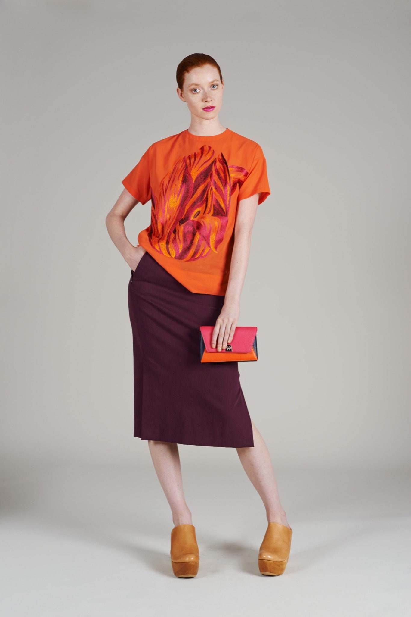 orange printed top with purple skirt