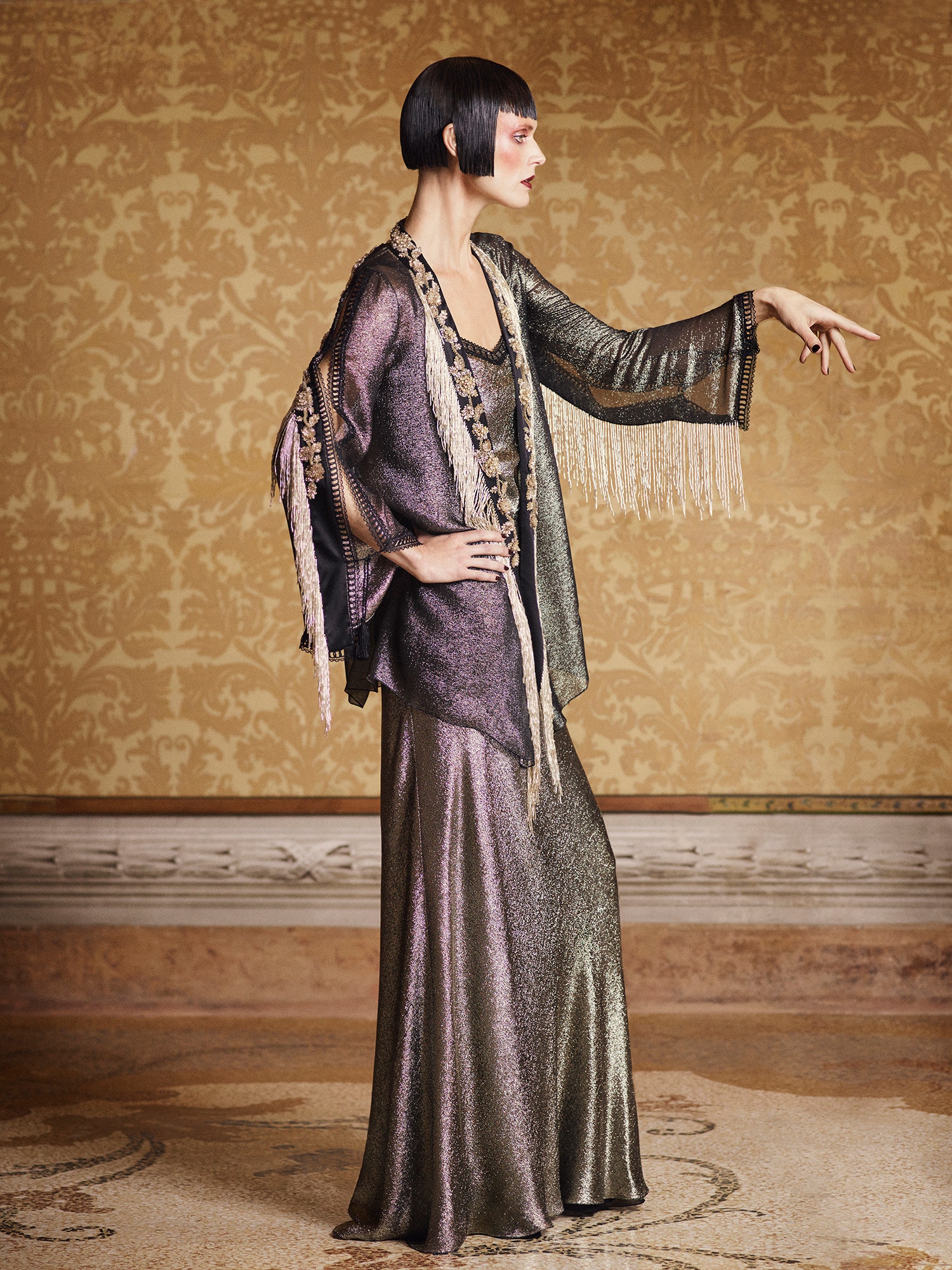 gold and purple draped gown with cape