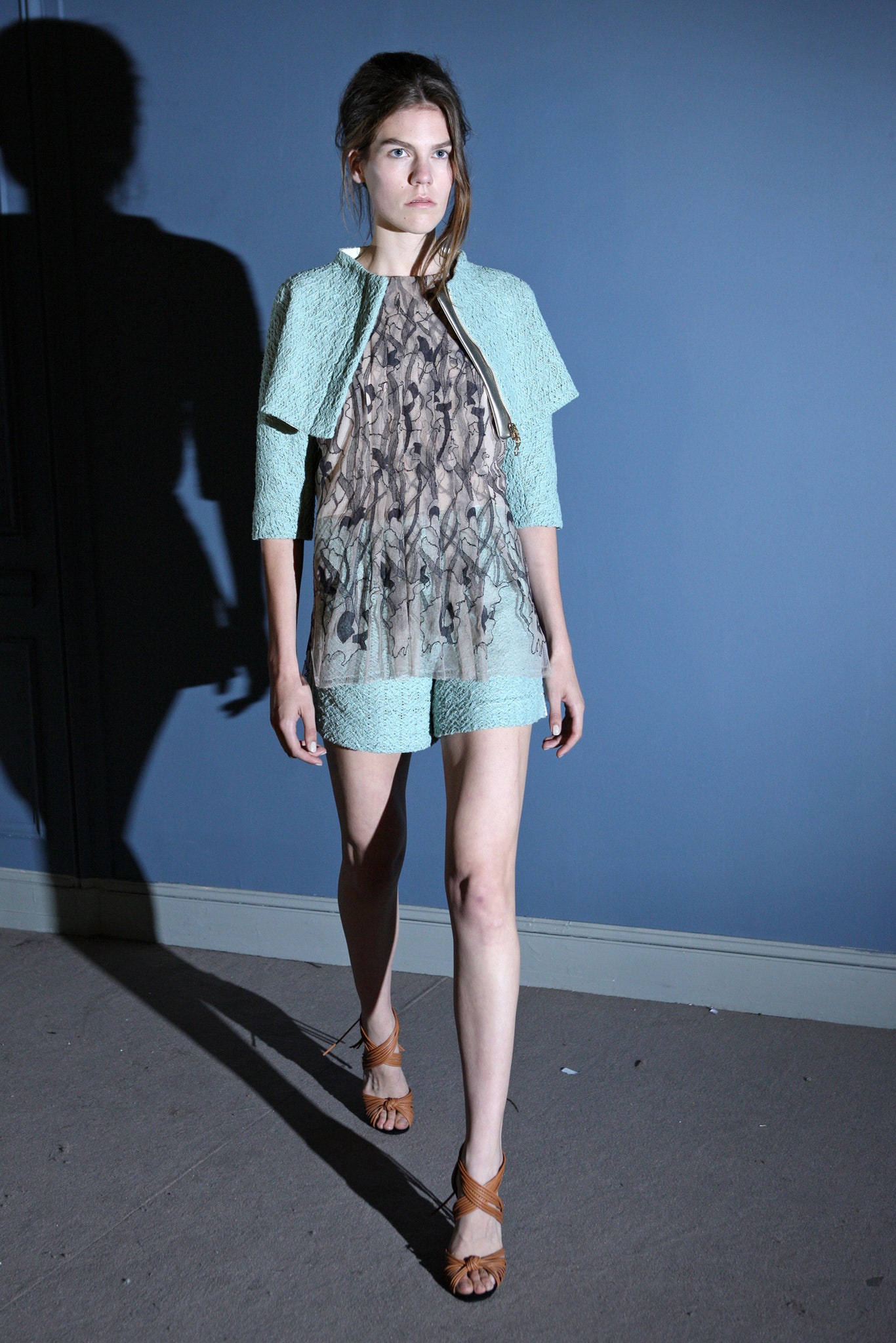 blue silk fitted top with beige shorts