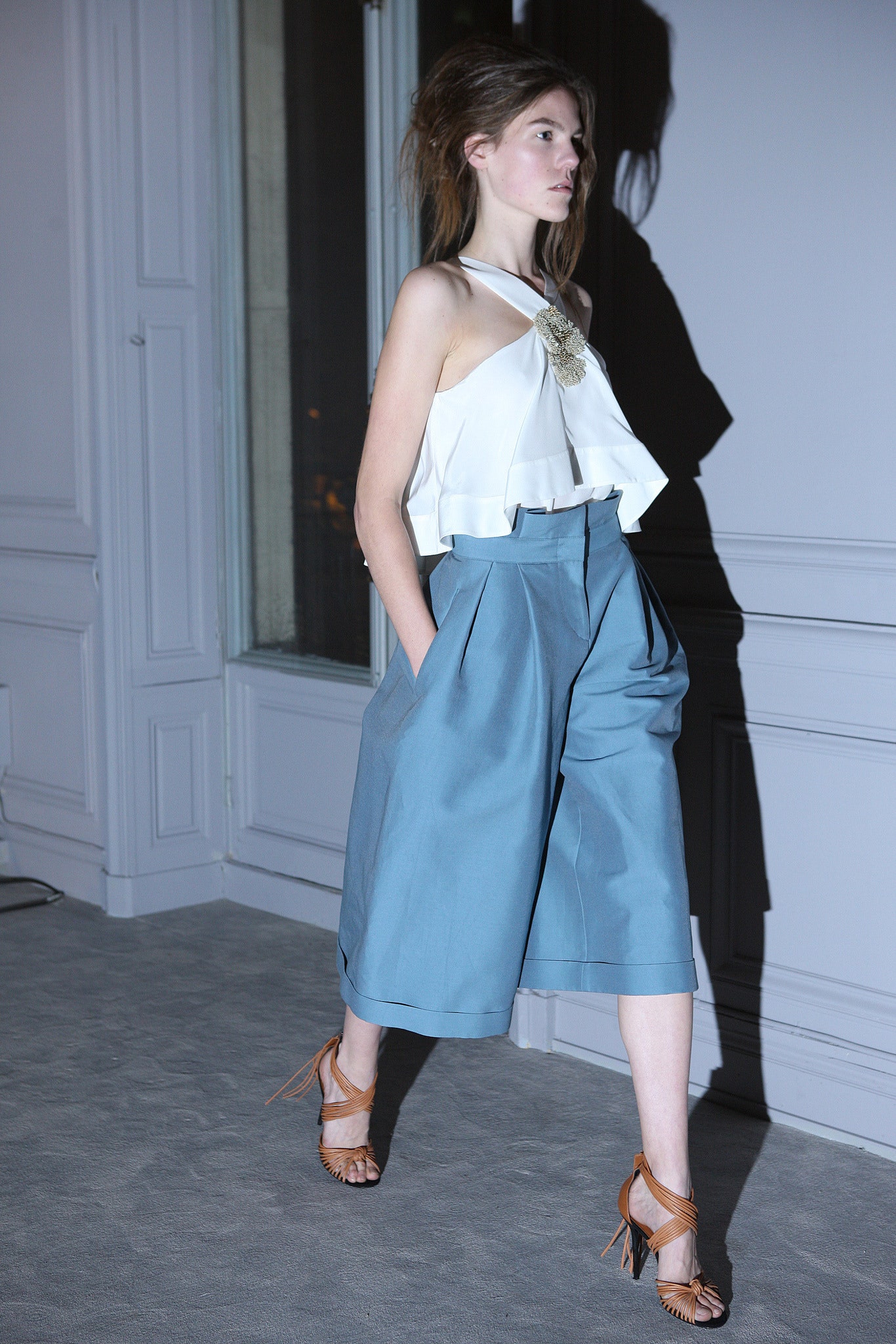white silk halter top with blue wide-leg pants