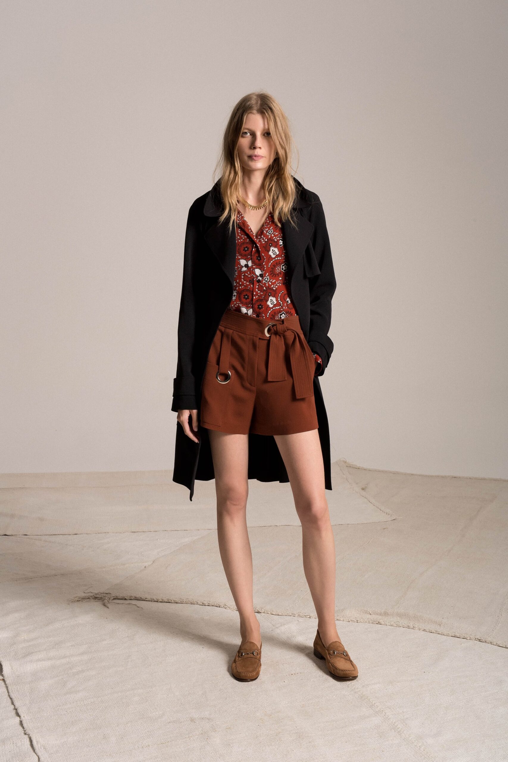black coat red blouse brown shorts