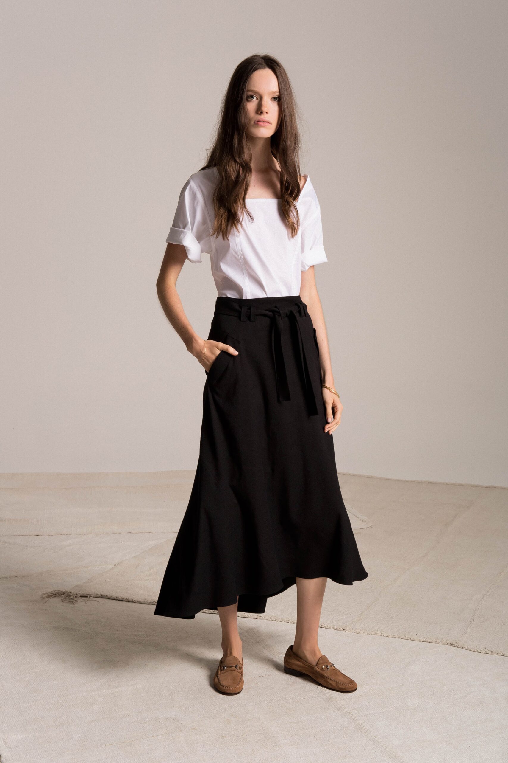 white off-shoulder top with black flared skirt