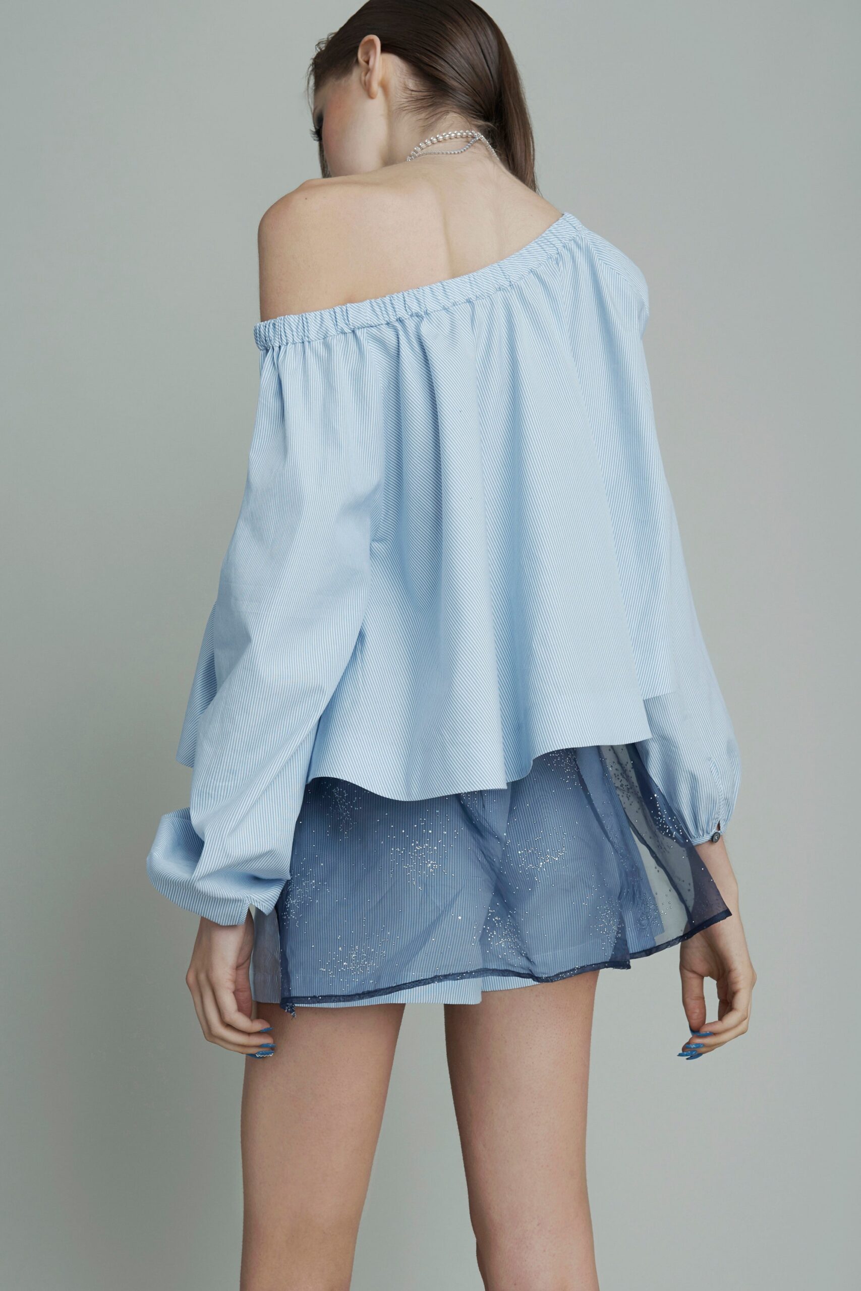 blue off-shoulder top with pleated mini skirt