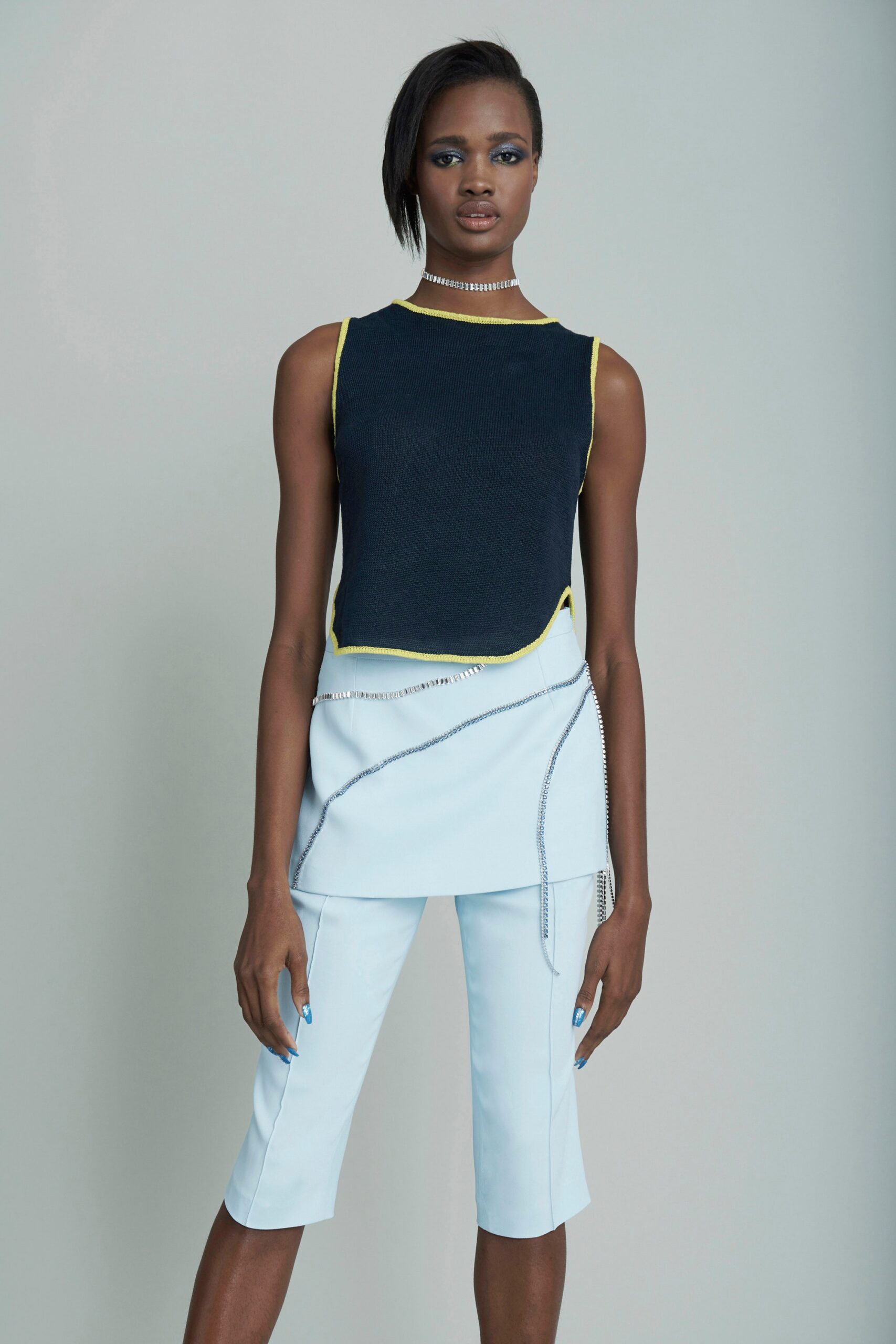 black sleeveless top with light blue pants