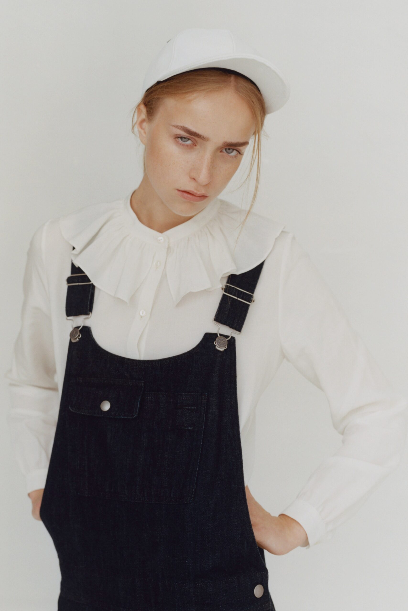 white collared shirt with blue overalls