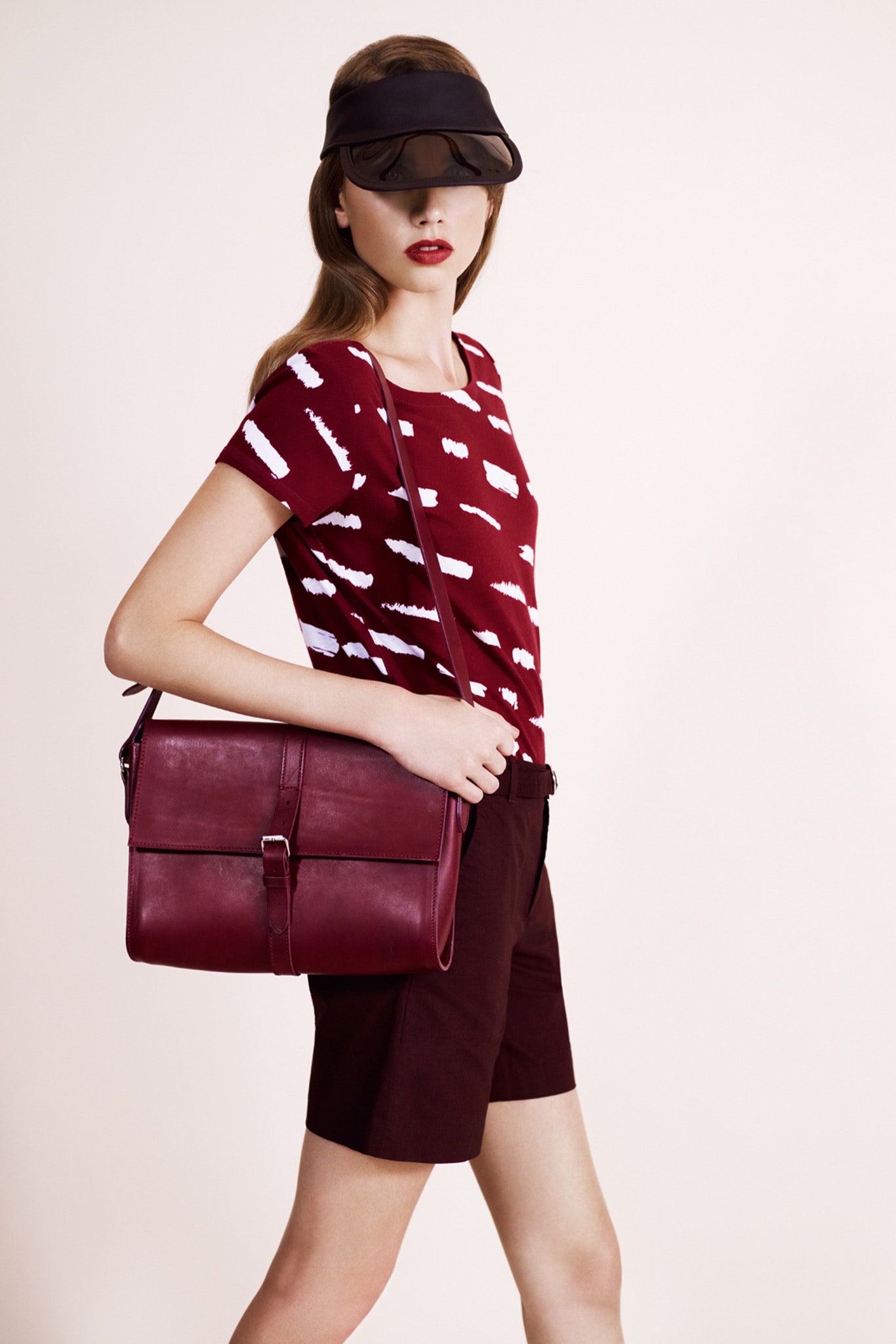 red printed top with brown shorts