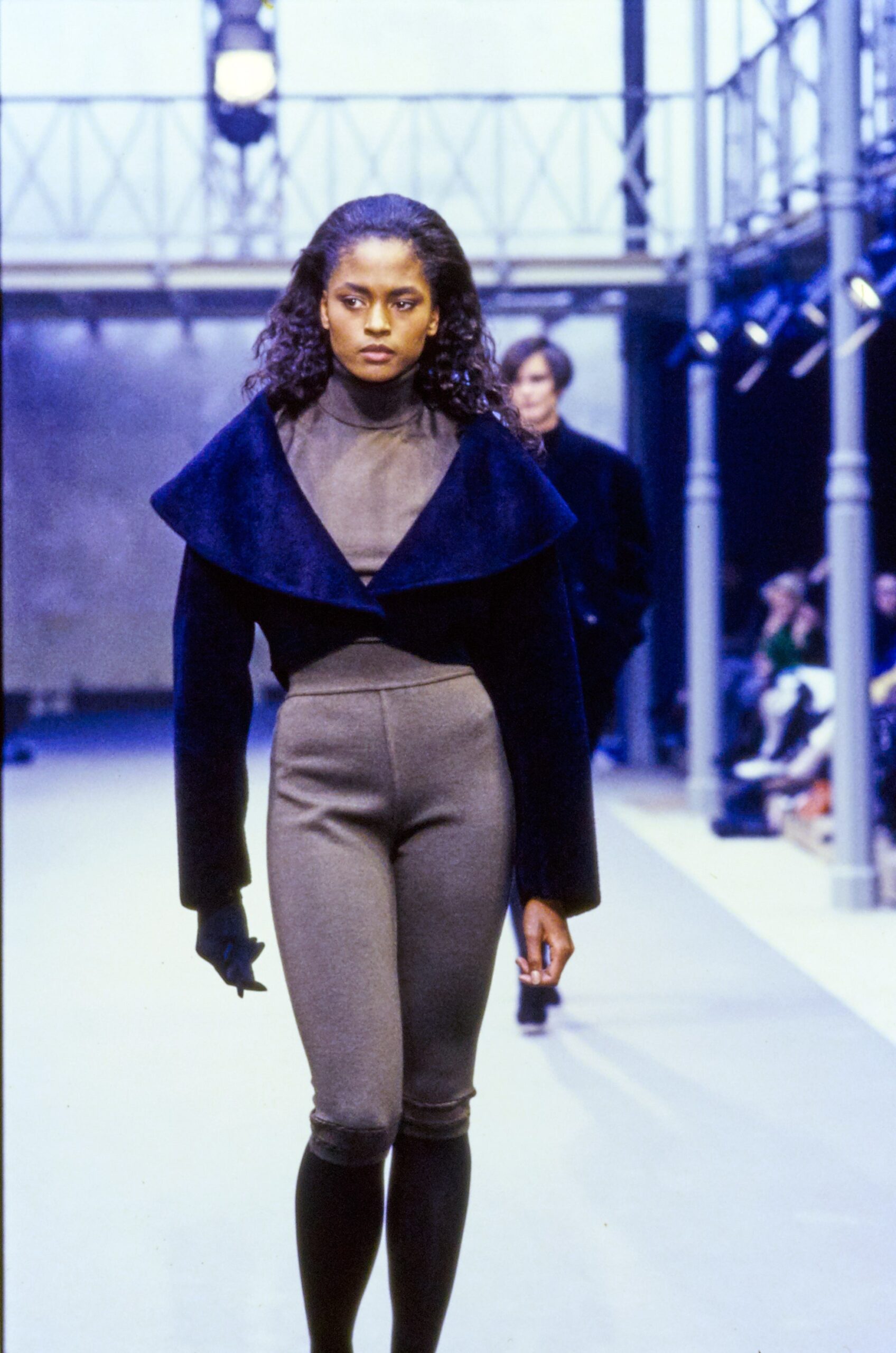black faux-fur jacket gray bodysuit black pants