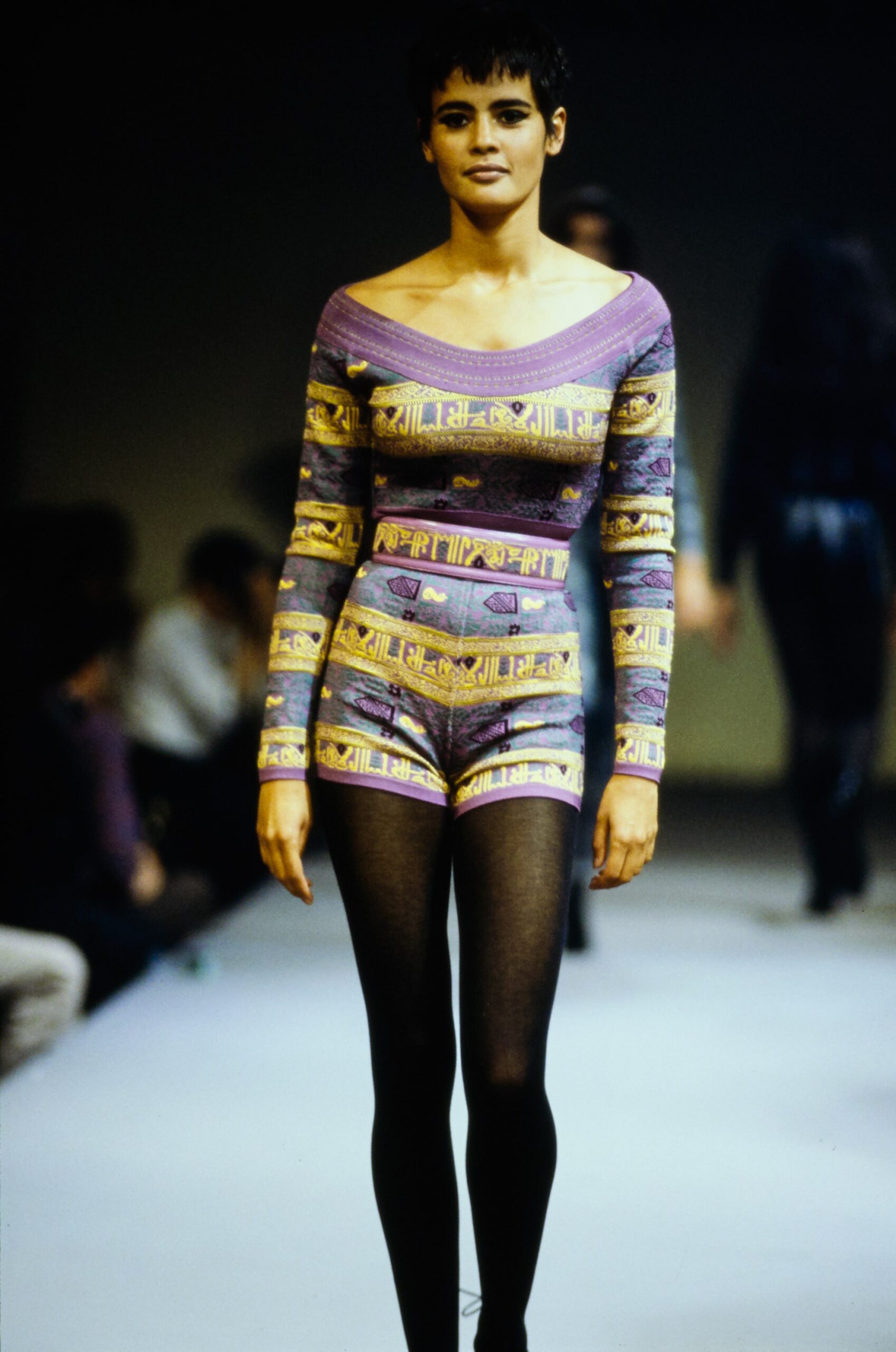 purple printed romper with black leggings