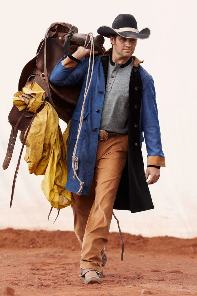 blue coat with gray shirt and tan pants