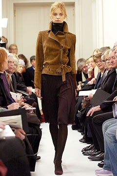 brown suede fitted jacket and black pleated skirt