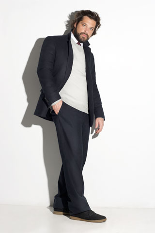 black tailored suit with gray sweater