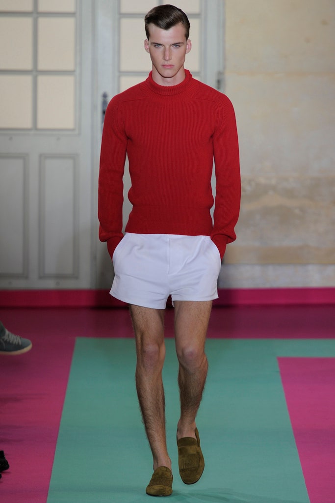 red fitted sweater and white shorts