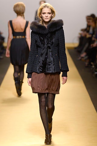 black fur coat with pleated brown skirt
