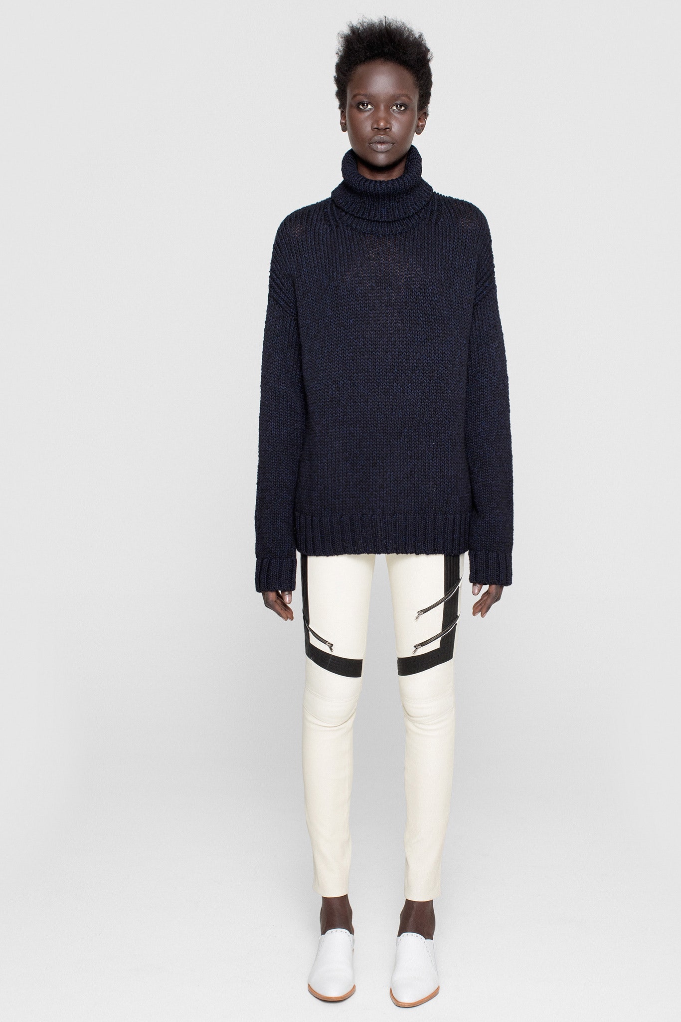 oversized black wool sweater and fitted white pants