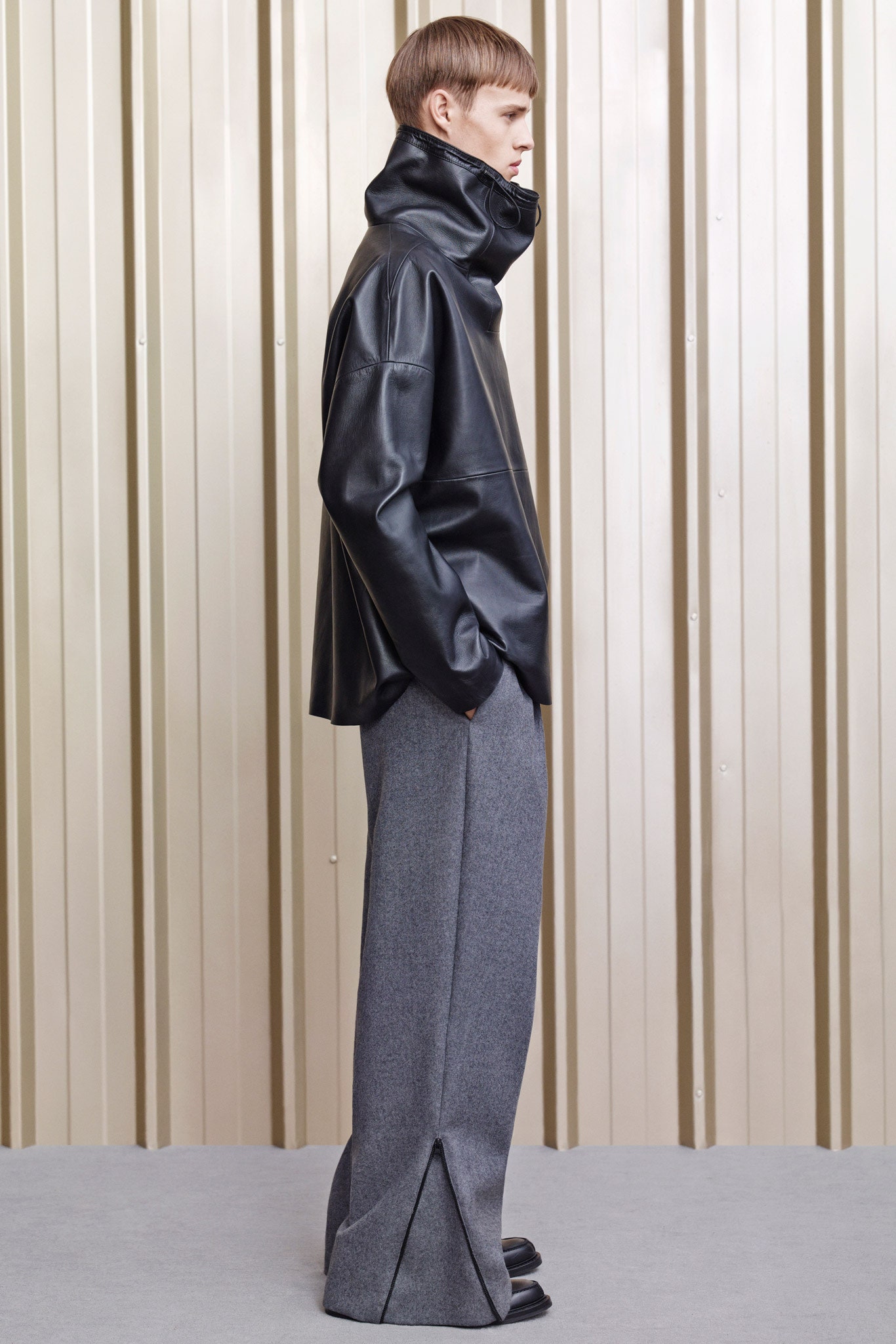 black leather oversized jacket and gray wool pants