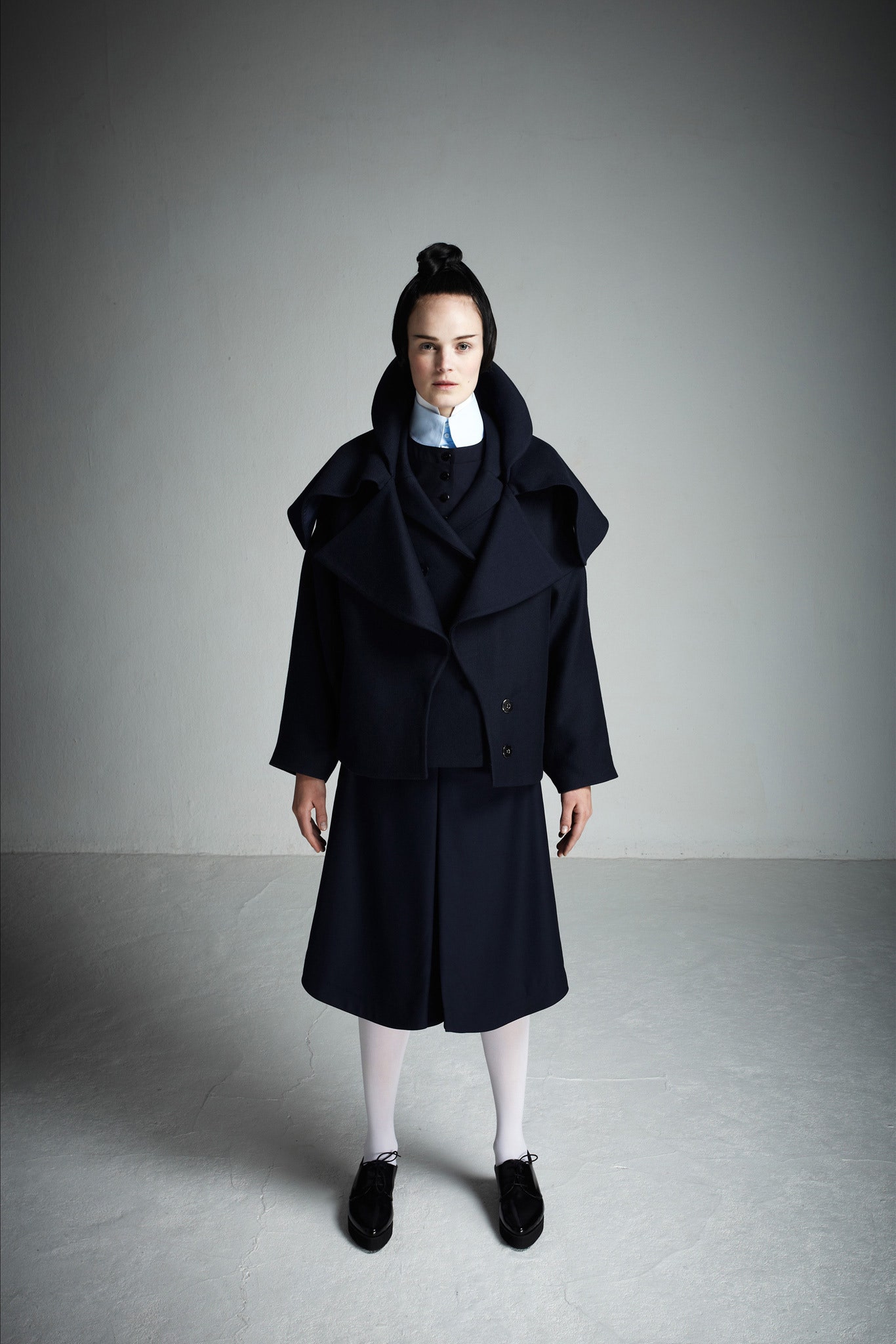 black wool coat with white blouse