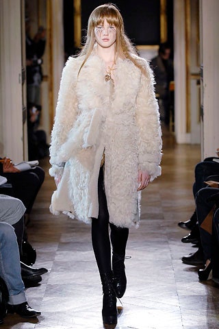 white fur coat with black leggings