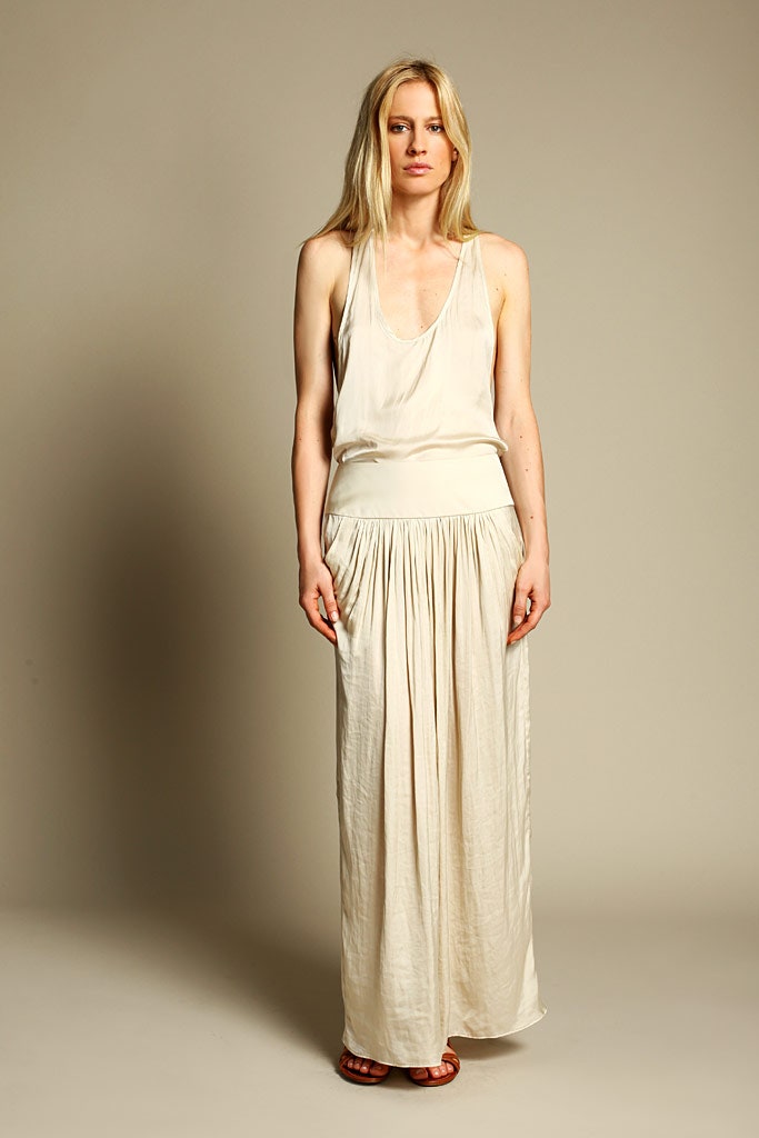 beige silk sleeveless top and pleated skirt