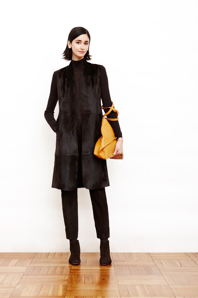 black fur vest with orange bag