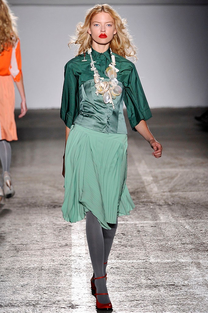 green silk blouse with pleated skirt