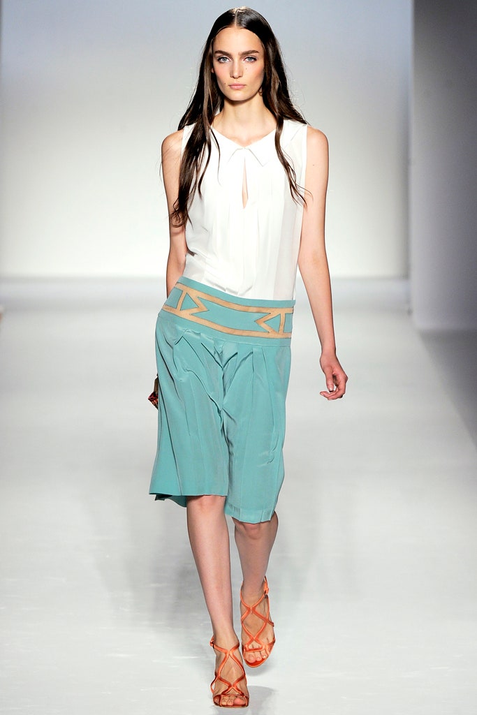 white silk sleeveless top and blue skirt