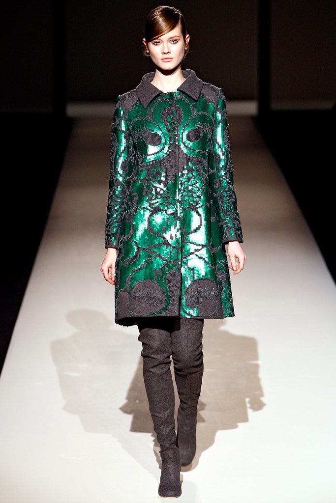 green embroidered coat with gray boots