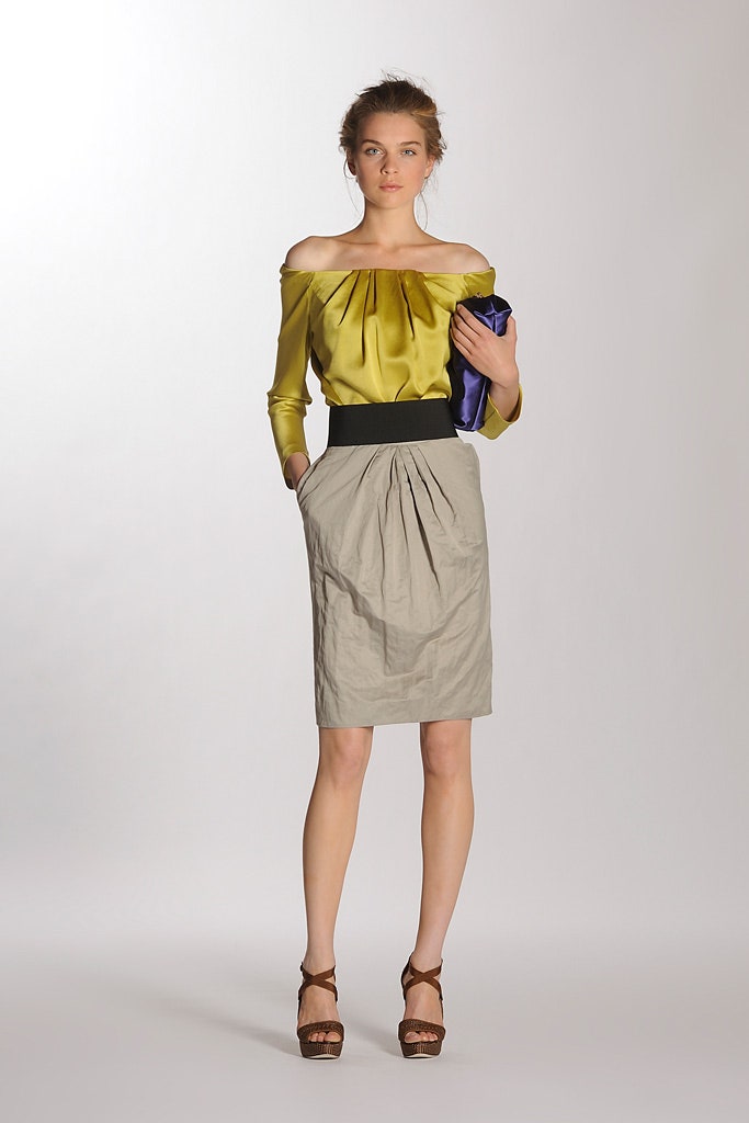 yellow silk off-shoulder blouse and beige pleated skirt