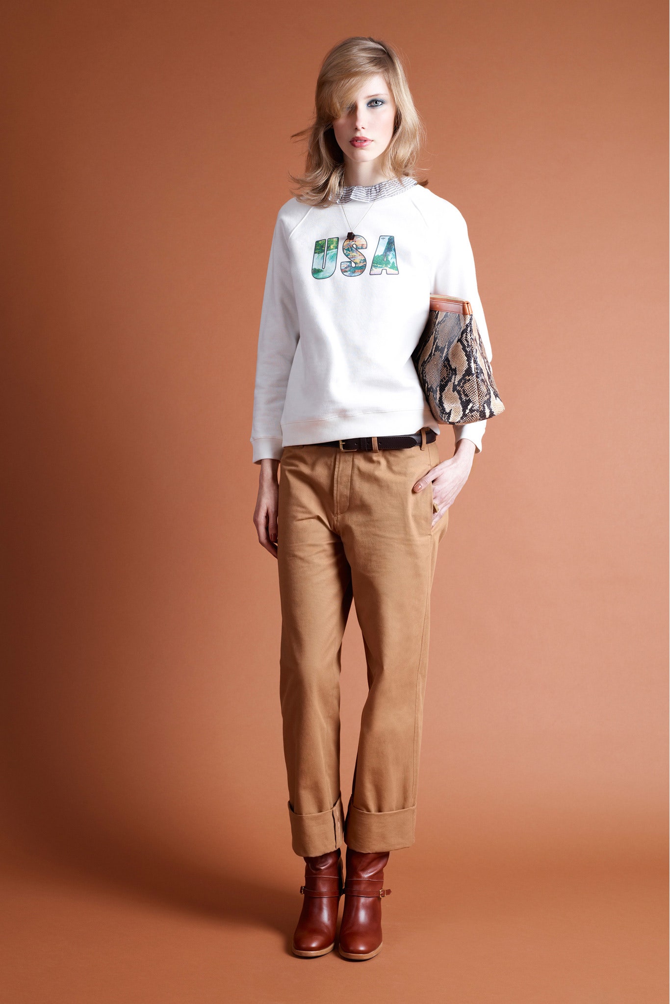white printed sweater with beige pants