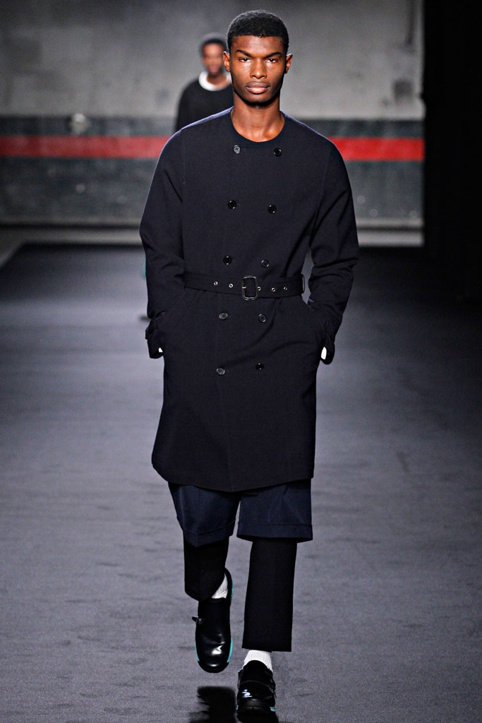 black tailored coat and relaxed pants