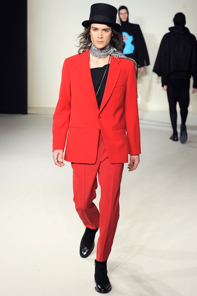 red tailored suit with black accessories