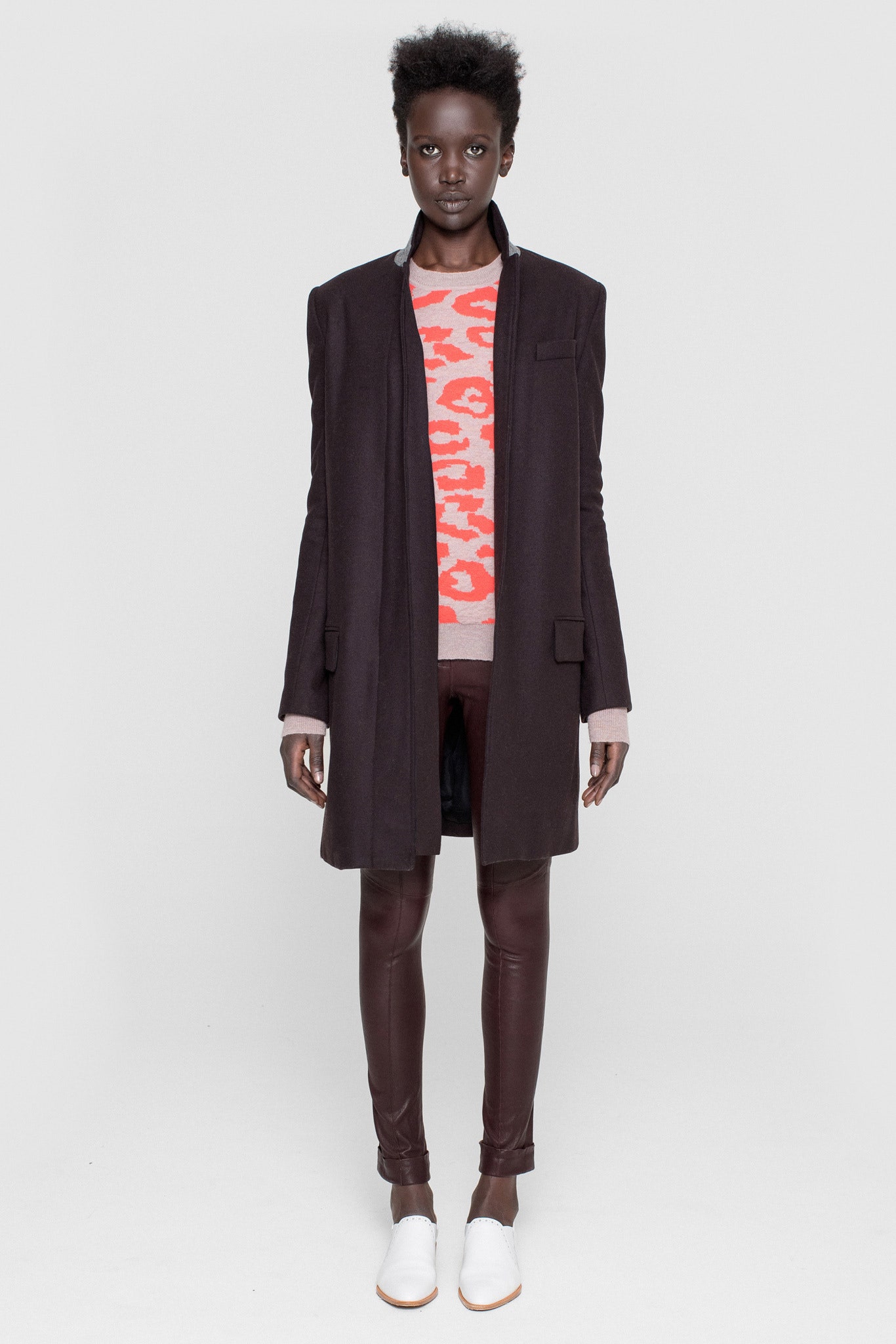 black tailored coat with printed sweater