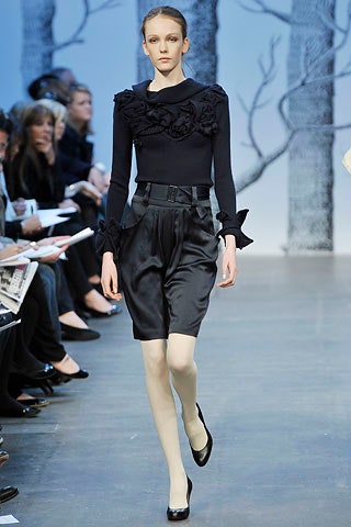 black ruffled top with pleated shorts