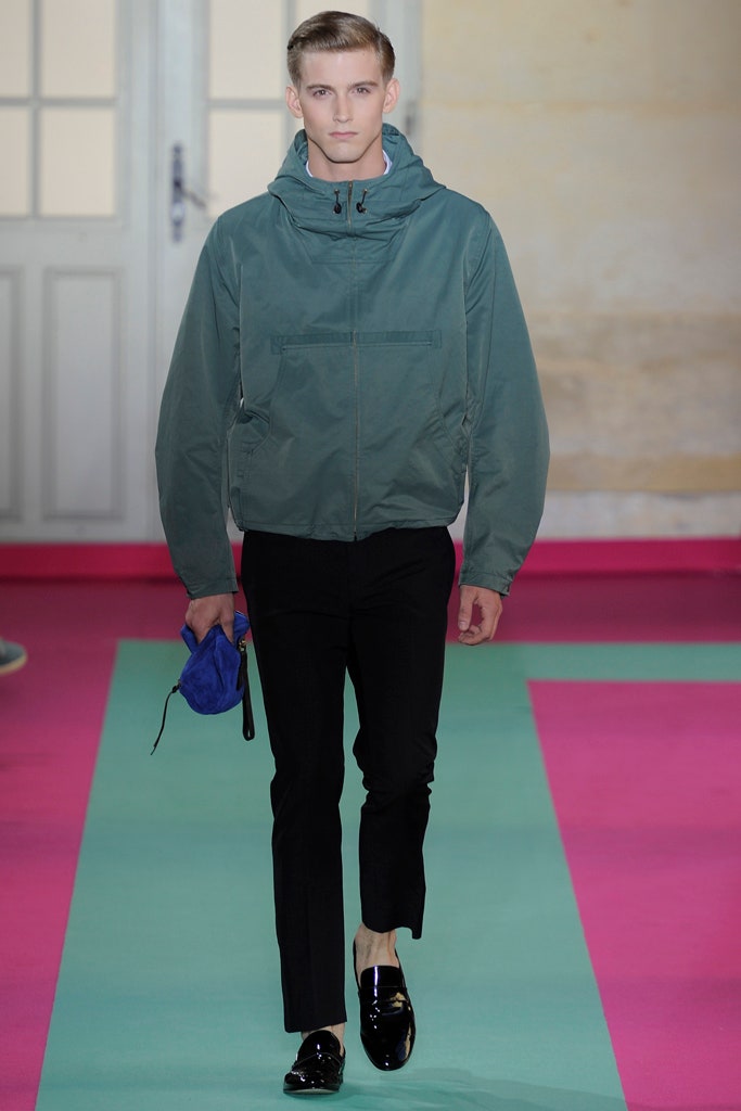 green hooded jacket with black pants