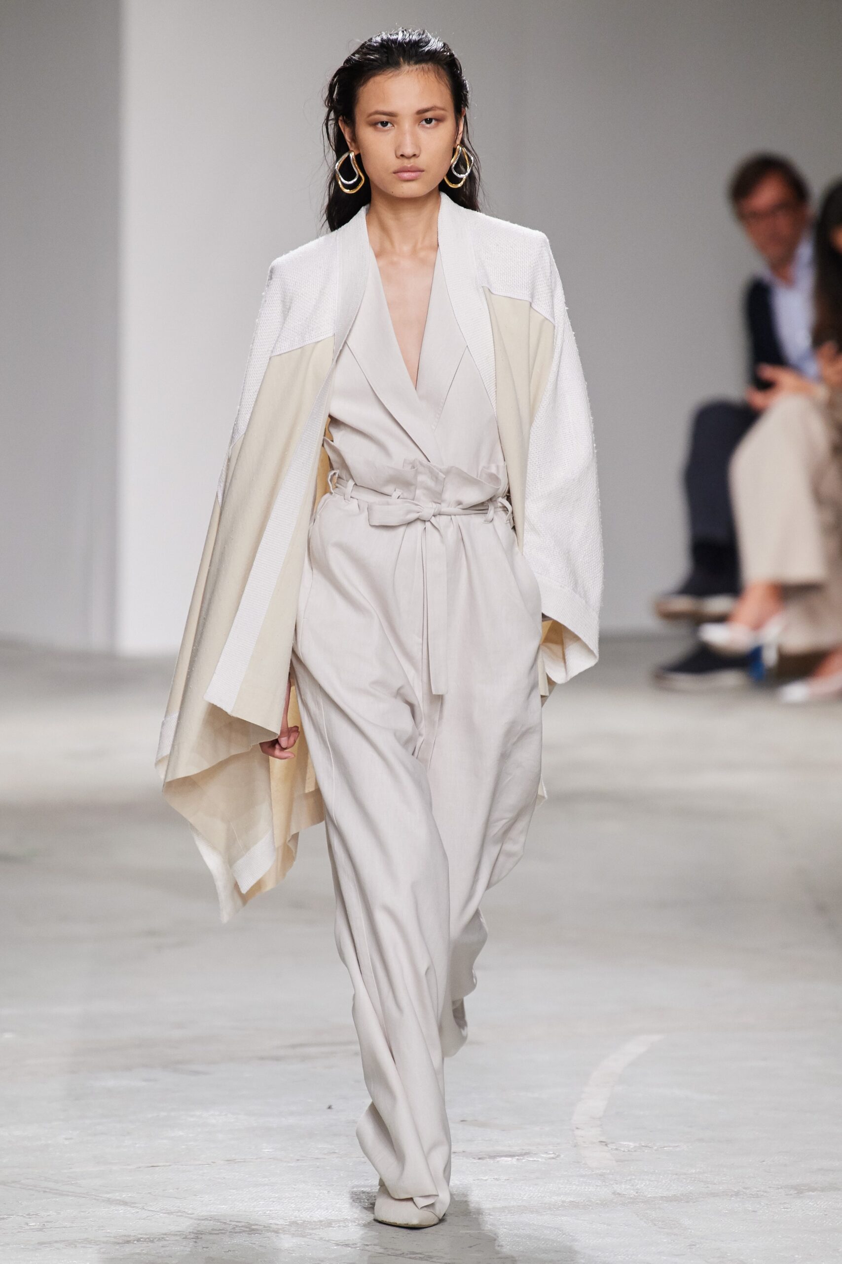beige fitted jumpsuit with white cape