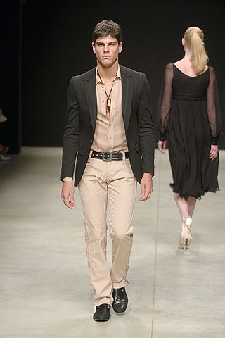 black tailored suit with beige shirt