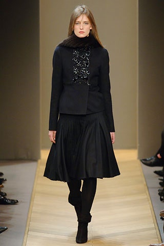 black fitted blazer and pleated skirt