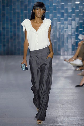 white silk ruffled blouse and gray linen pants