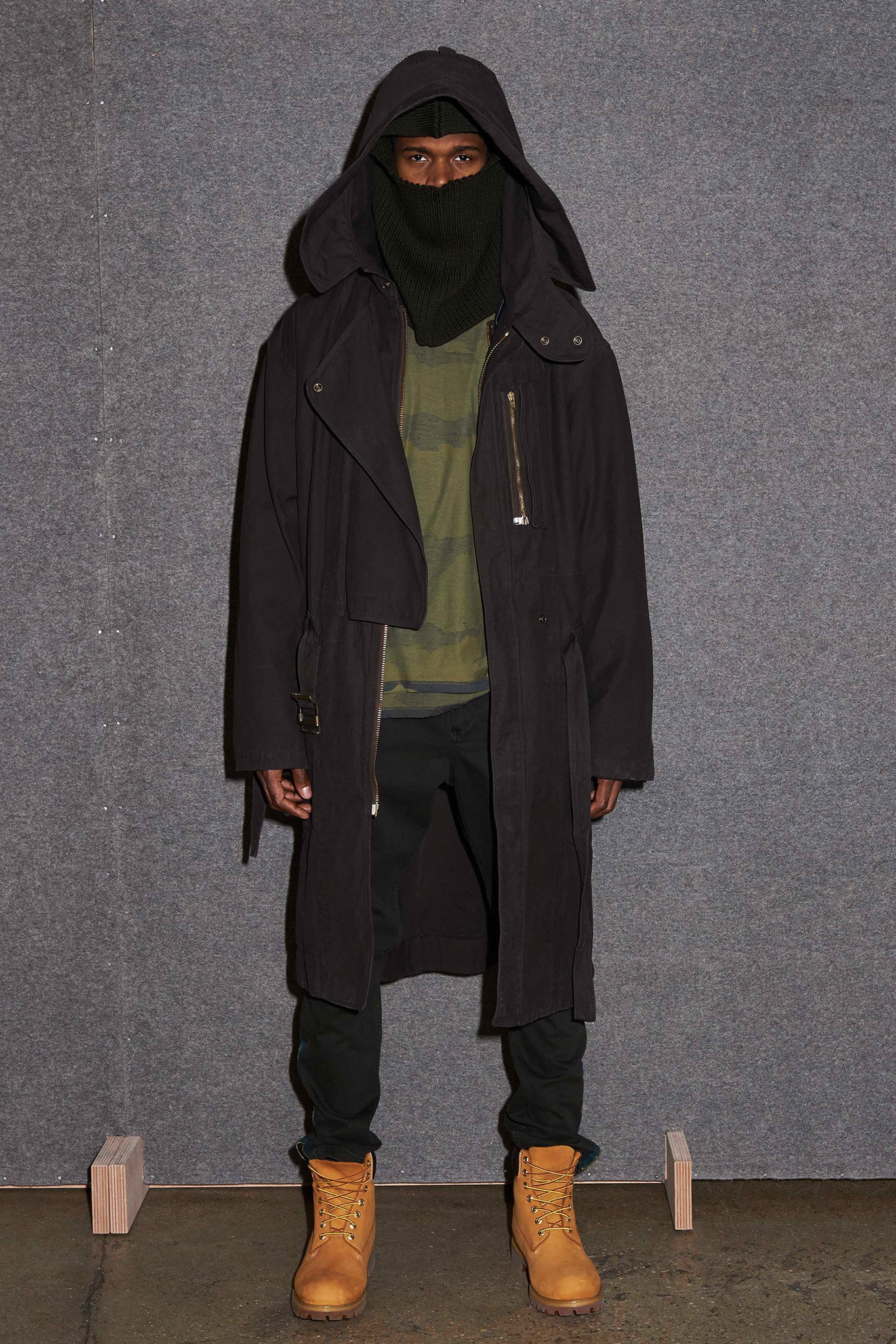 black trench coat with green sweater