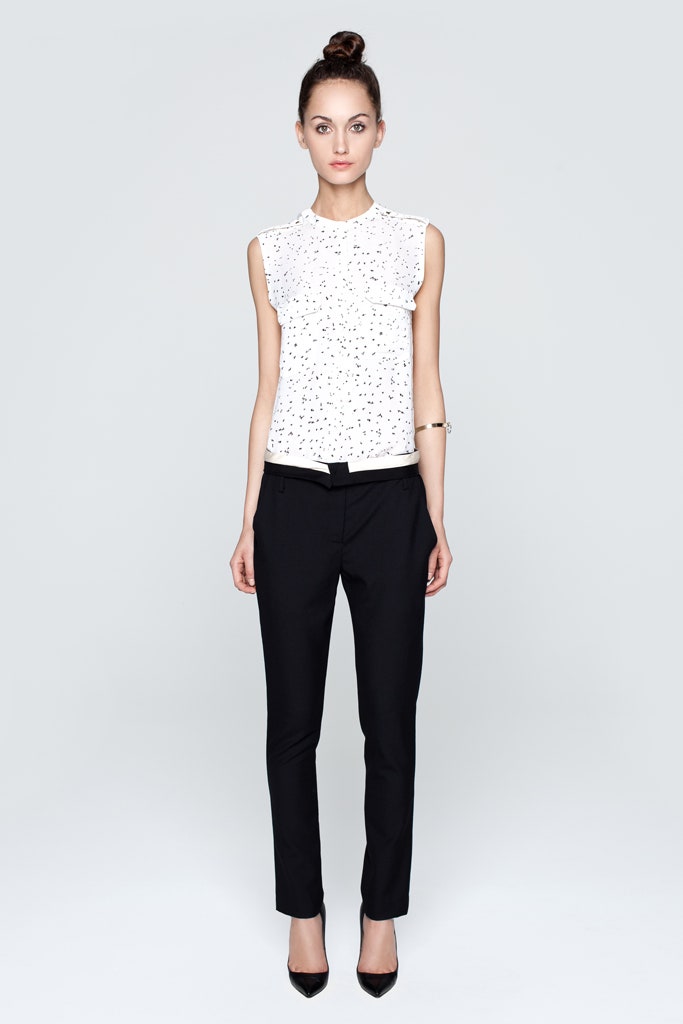 white printed sleeveless top with black pants