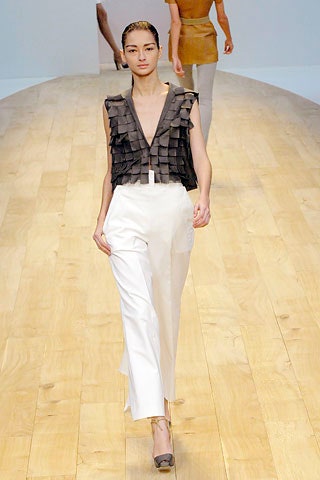 black ruffled top with white pants