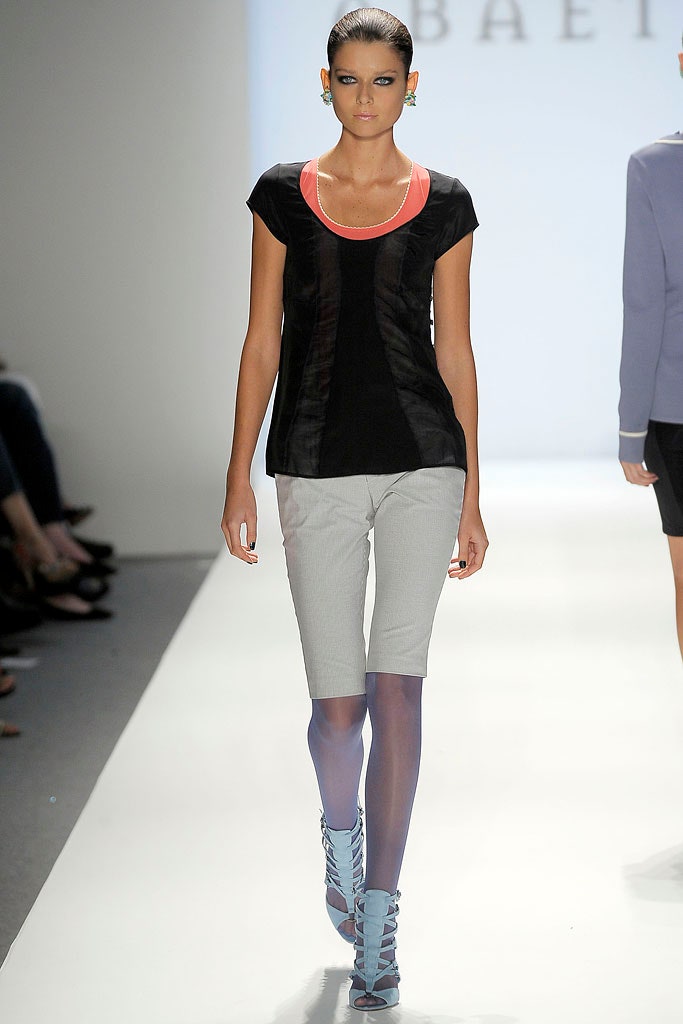 black and red fitted top with gray shorts